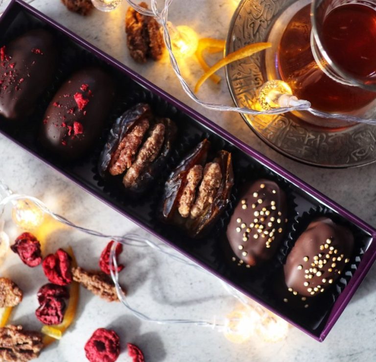 Arabic tea and chocolate covered and filled dates with roasted nuts and spices such as saffron and rose petals