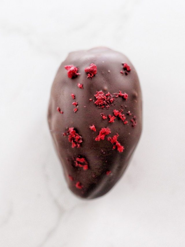 Dark chocolate coated date filled with Almonds, Vanilla and topped with zingy cherries